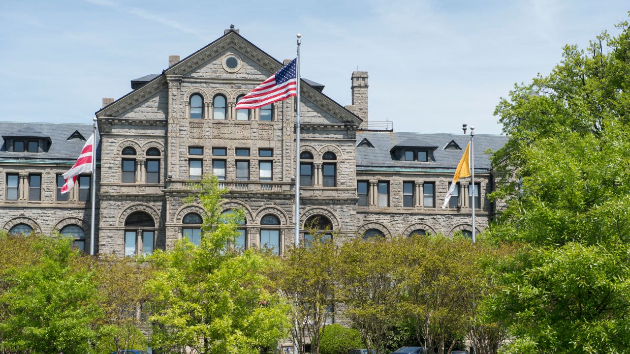 Three Flags Flying in front of McMahon Hall